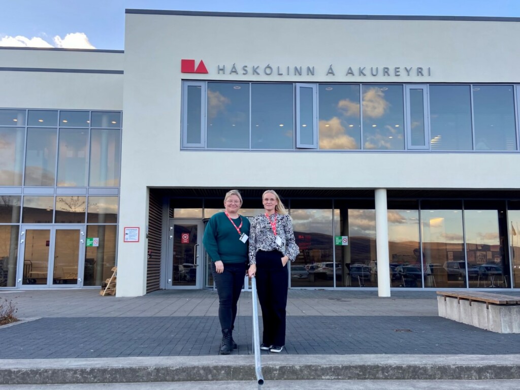 Two women standing outside a big building